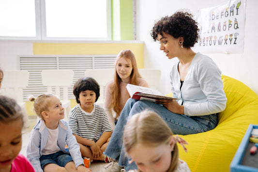 children sitting around teacher in a classroom