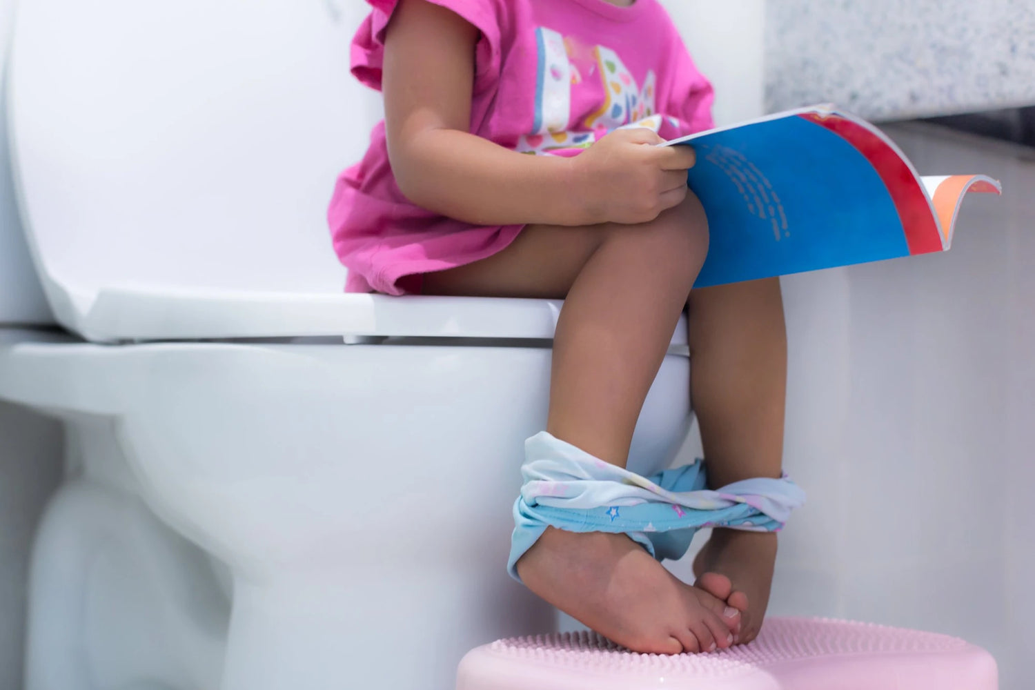 girl on toilet potty training
