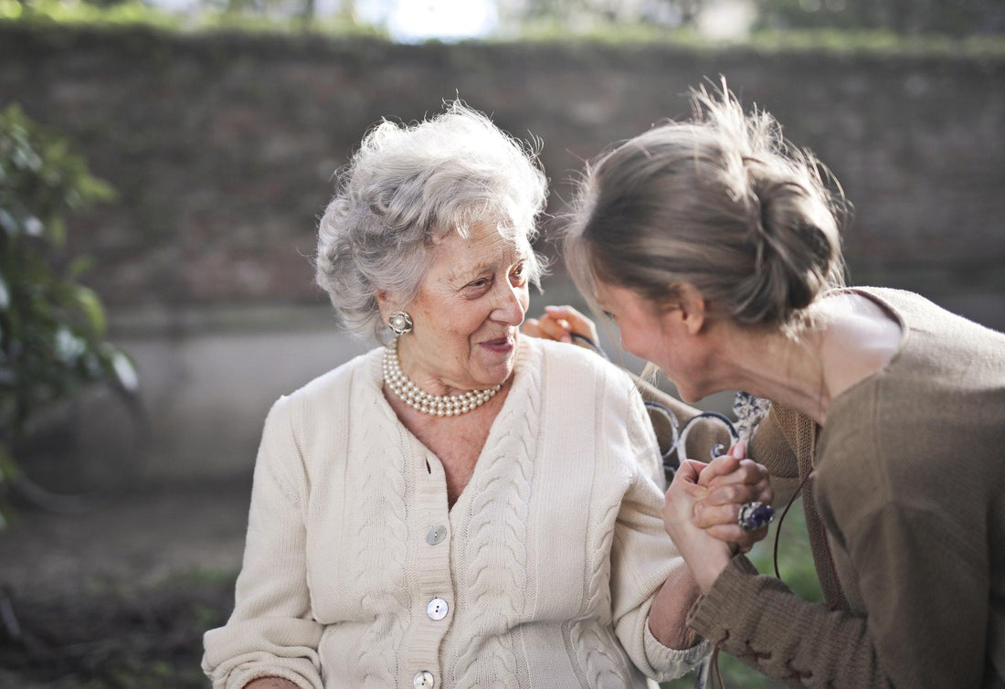 elderly woman and daughter laughing together