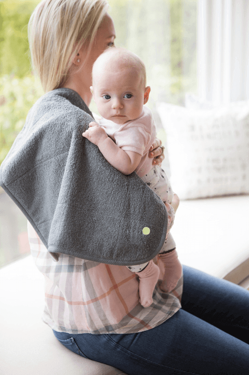 Mother using PeapodMat to protect clothing while nursing