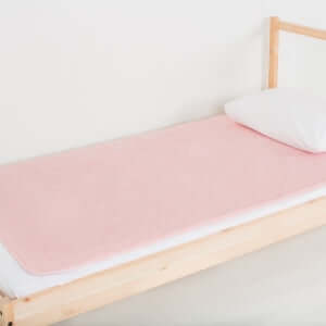 Large PeapodMat in Fuzzy Peach colour on a single bed